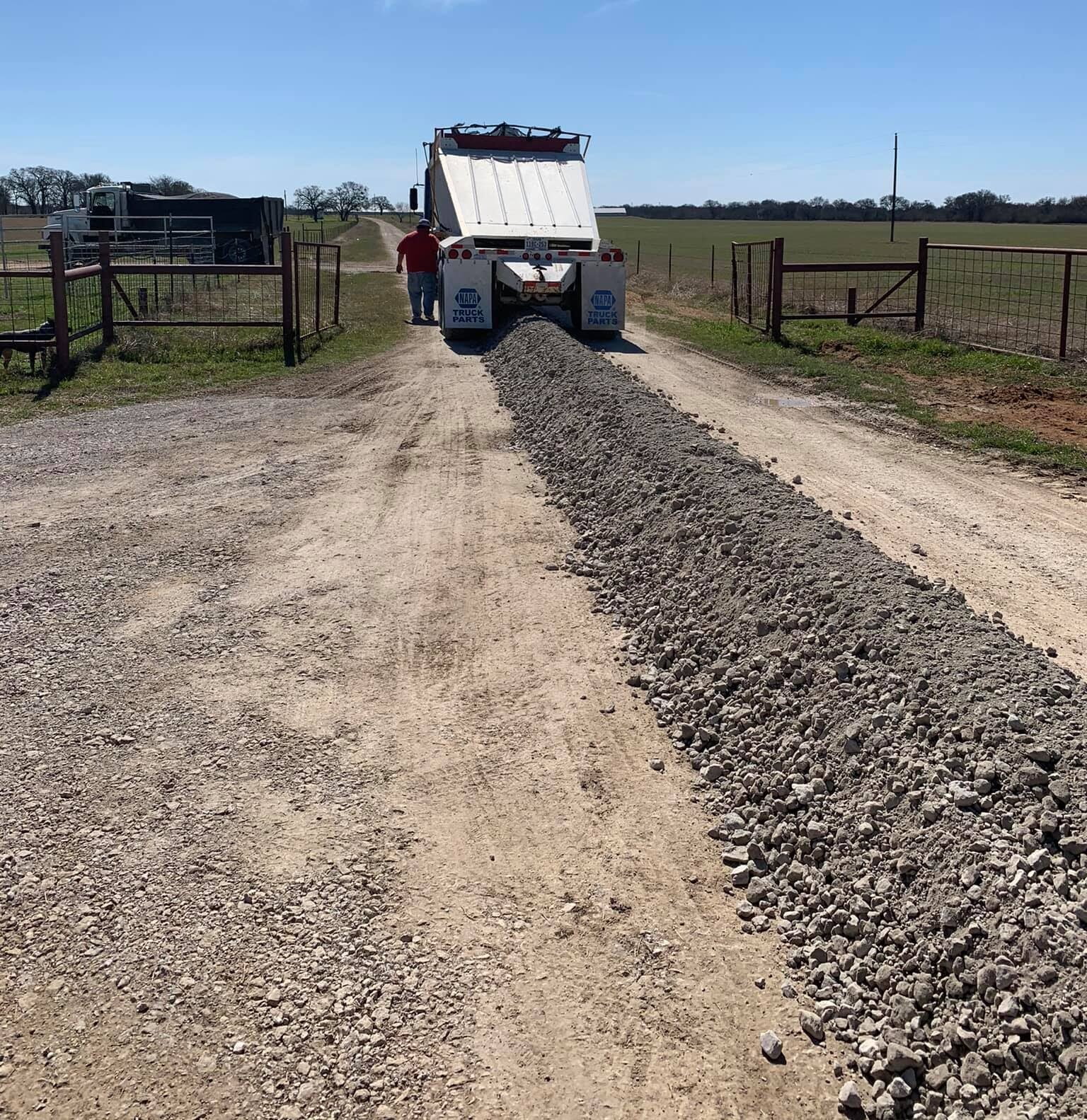 Belly Dump Hauler spreading road base in Central Texas ~ David Neal Trucking